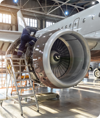 Technician performing engine MRO in a hangar